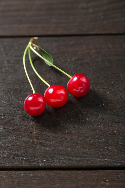 Fresh cherry on a wooden table. - Фото, изображение