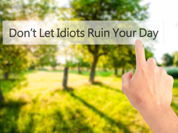 Don't Let Idiots Ruin Your Day - Hand pressing a button on blurr - Photo, Image