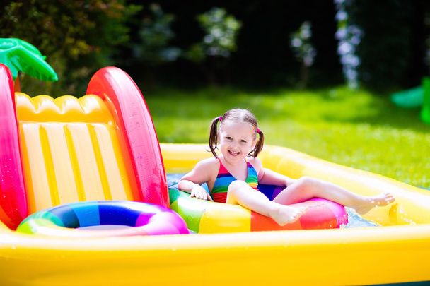 Little girl in garden swimming pool - Photo, Image