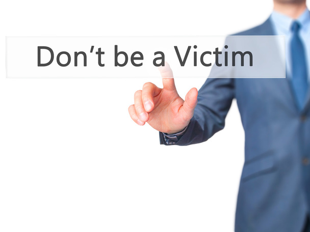 Don't be a Victim - Businessman hand pressing button on touch sc - Photo, Image