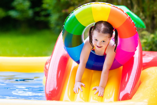 Little girl in garden swimming pool - Photo, Image
