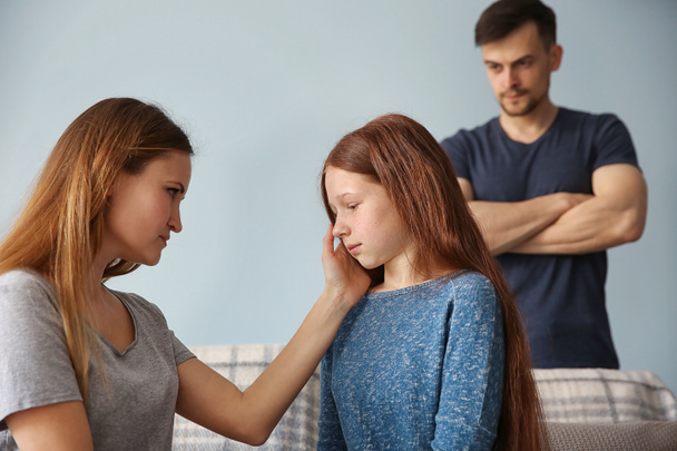 Family problems concept. Angry father and mother becalming girl - Photo, image