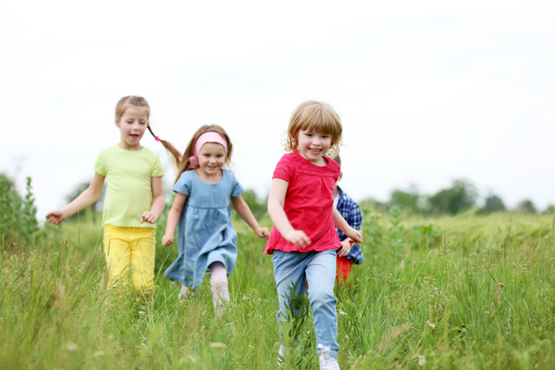 Children having fun outdoor - Foto, afbeelding