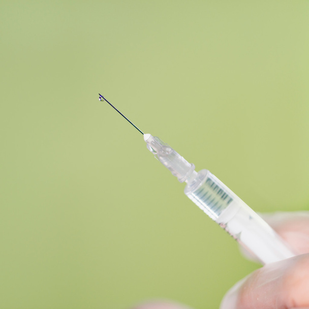 hand holding syringe  - Photo, Image