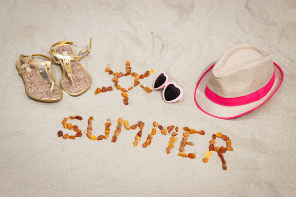 Shape of sun and word summer, accessories for vacation on sand at beach, sun protection, summer time - Photo, Image