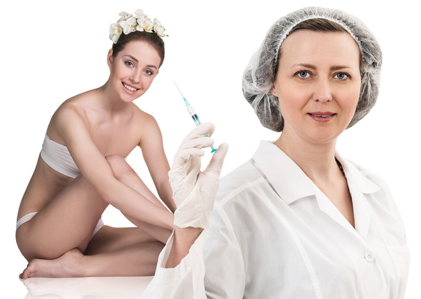 Female doctor with syringe stands near patient - Photo, Image