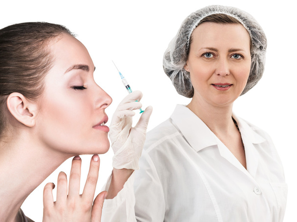 Beautiful woman face near doctor with syringe - Photo, image