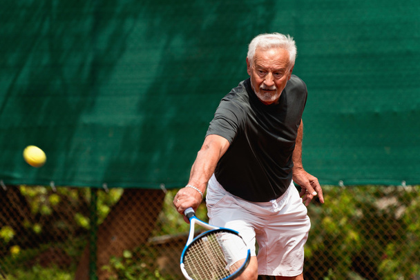 active  Senior man playing tennis - Photo, Image