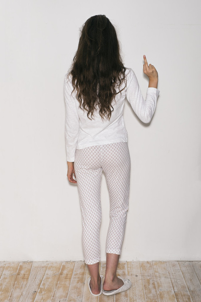 back view of brunette in pyjamas and slippers showing fuck - Zdjęcie, obraz