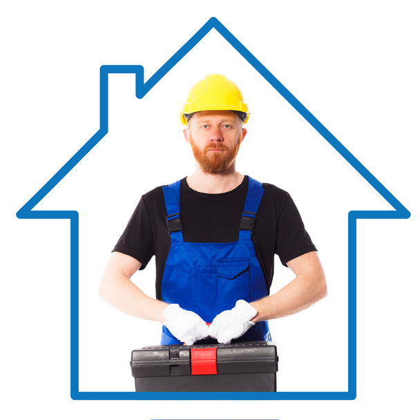 Людина будівельник у синій формений одяг - Фото, зображення