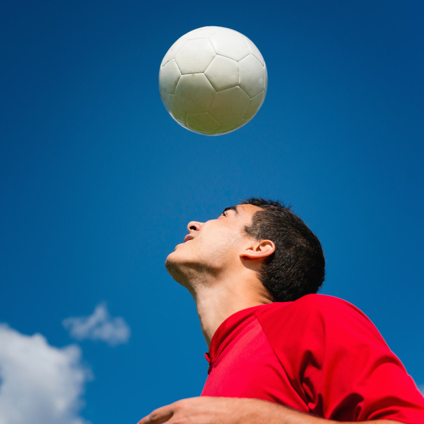 Soccer player with ball over head - Фото, зображення