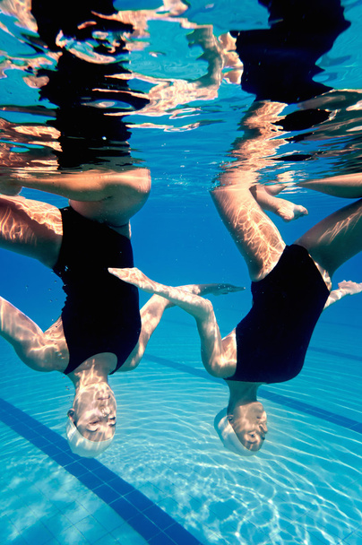 Synchronized swimming duet underwater - Фото, изображение