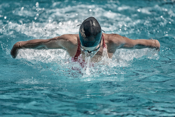 swimmer performing butterfly style swimming - Photo, Image