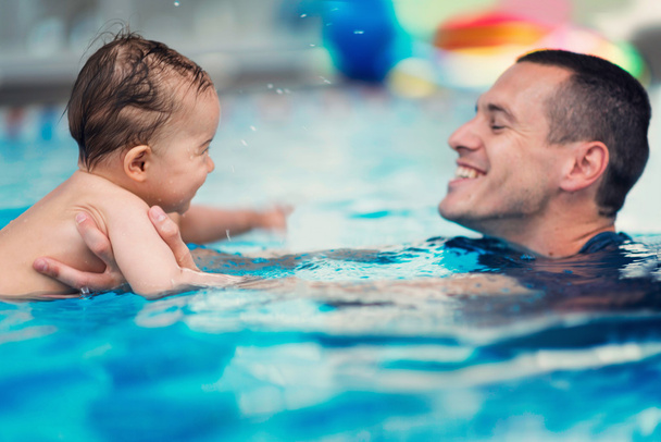 Instructor with baby boy on swimming class - Photo, Image