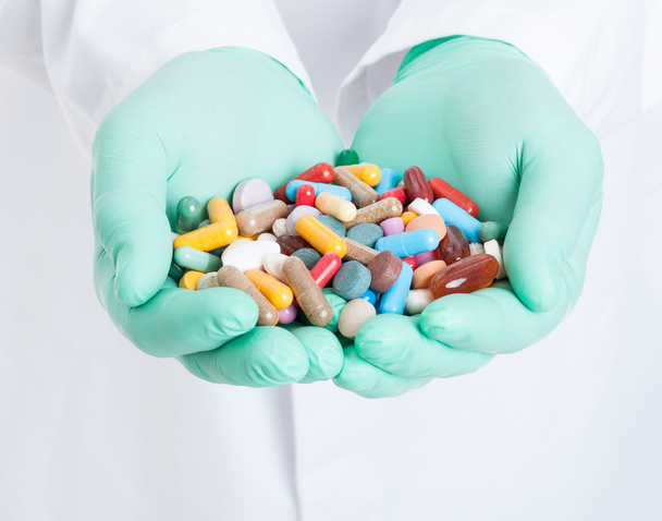 Close-up of hands holding bunch of colored pills - Φωτογραφία, εικόνα