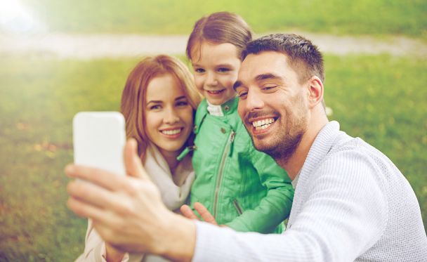 happy family taking selfie by smartphone  - Fotó, kép