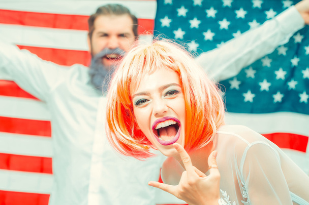 Happy young patriotic Americans bright make up and hair celebrating Independence Day on 4th of July - Photo, Image