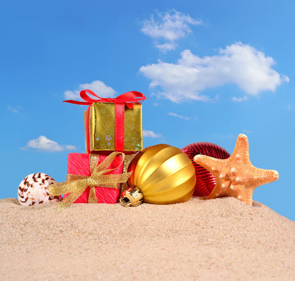 Christmas decorations seashells and starfish on a beach sand - Photo, Image