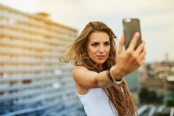 woman taking selfie on the rooftop - Zdjęcie, obraz