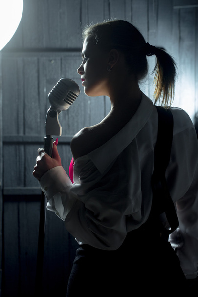 sensual woman with microphone - Foto, afbeelding