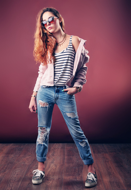 Sexy hip-hop woman in cap with long red hair. Fashion portrait of modern girl in cap - Photo, Image