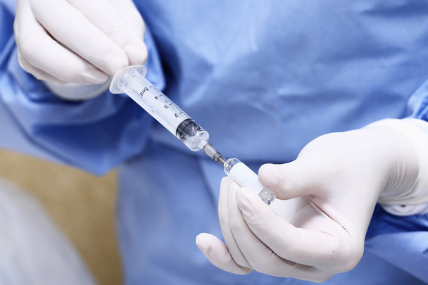 Hands of the doctors filling a syringe. - Photo, Image