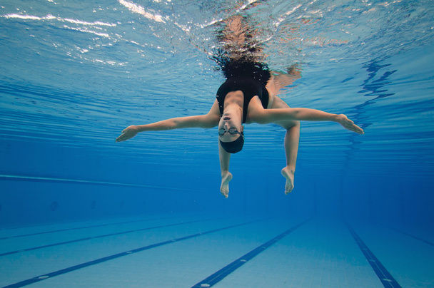 synchronized swimmer performing underwater - Photo, Image