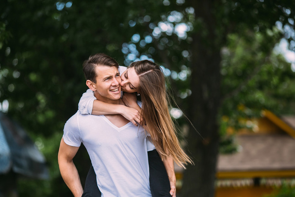 Young adult brunette man and woman in the park - Photo, Image