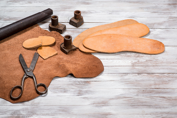 A lot of work tools and leather for shoemaker.Leather craft. Copy space. - Photo, Image