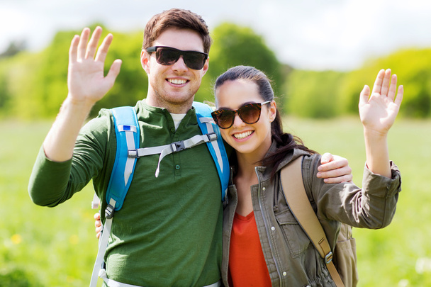 happy couple with backpacks hiking outdoors - Photo, Image