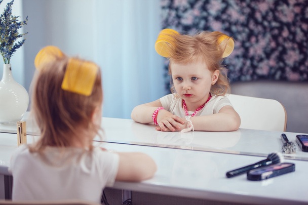 Little girl in front of the mirror doing her makeup - Photo, image