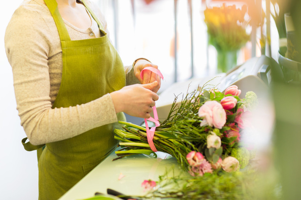 Woman making bunch at flower shop - Photo, image