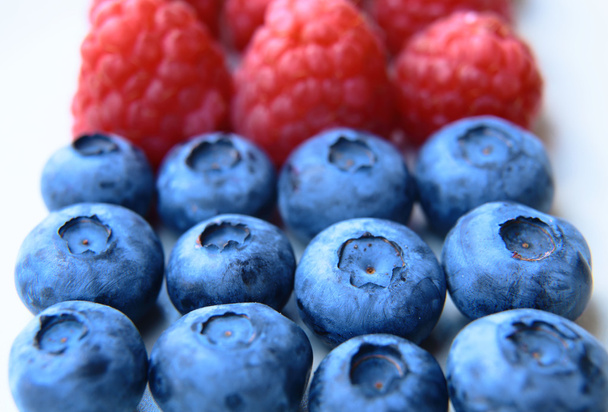 closeup of a bunch of raspberries and blueberries  - Photo, Image
