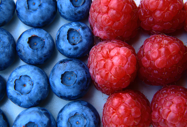 closeup of a bunch of raspberries and blueberries  - Photo, Image