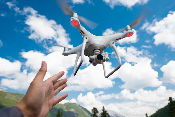 Hovering drone and a hand - Photo, Image
