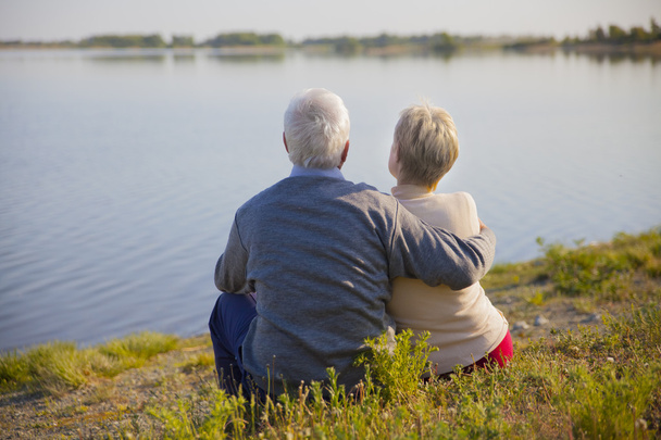 adult couple seniors on the shore of lake - Photo, Image