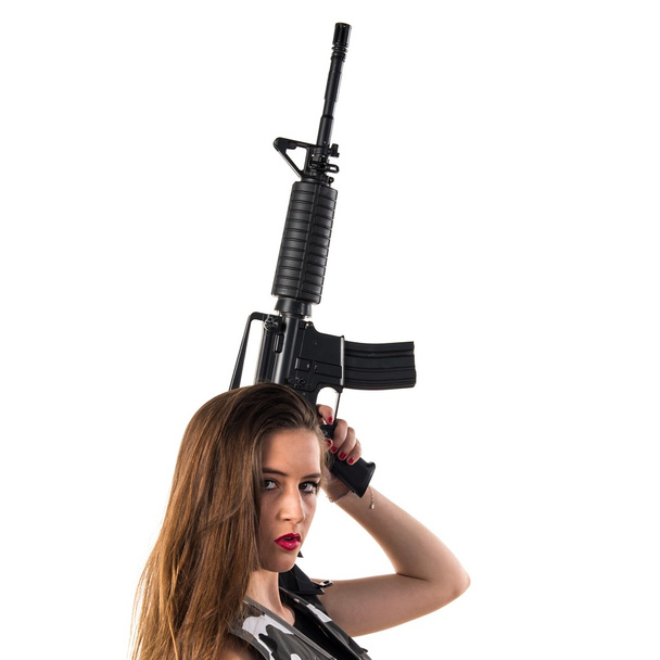 Young girl holding a rifle - Φωτογραφία, εικόνα