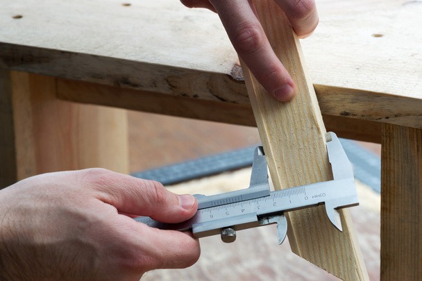 Carpenter working. Check measurement of blank. - Photo, Image