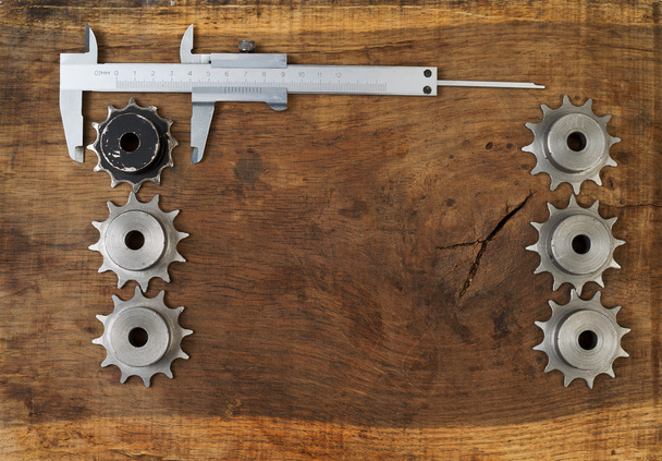 Engineering tools gears and caliper on wooden table. Success concept. - Photo, Image