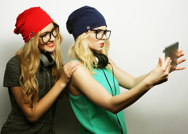 two hipster girls friends taking selfie - 写真・画像