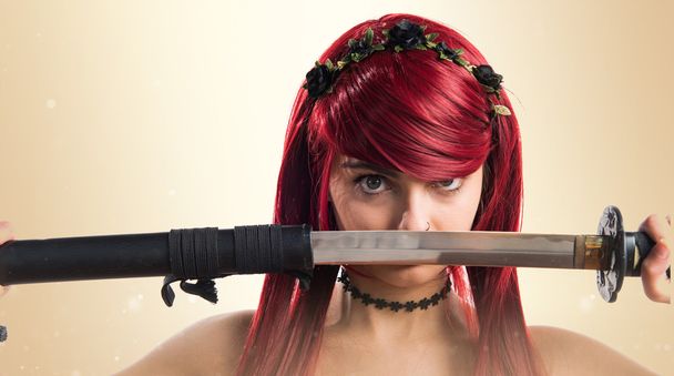 Young redhead girl with katana - Photo, Image
