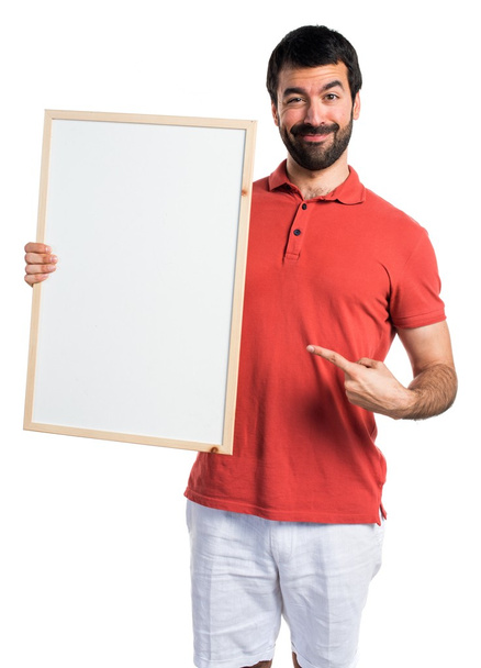Handsome man holding an empty placard - Foto, immagini