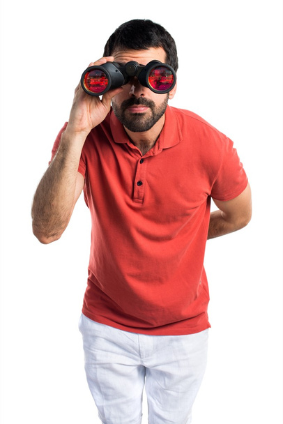 Handsome man with binoculars - Фото, изображение