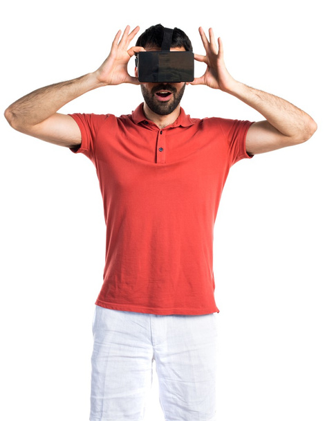 Surprised man using VR glasses - Photo, image