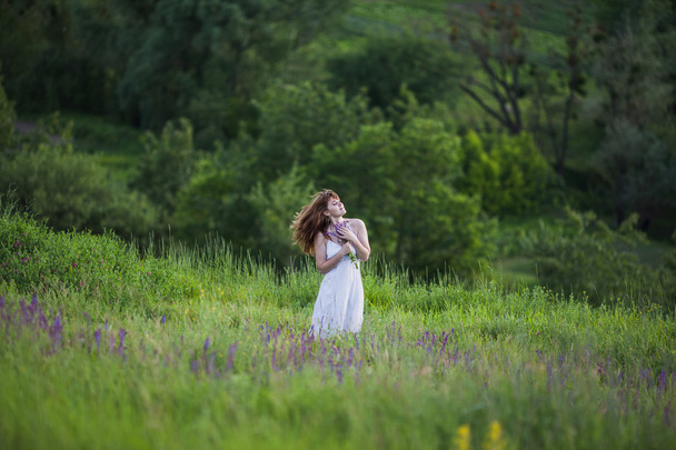 Beautiful girl in sage flower field. - Foto, Imagen