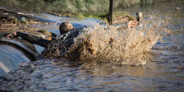 Deep muddy water with man slipping into the water - Photo, Image