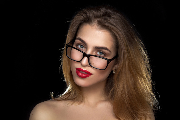 woman with glasses and red lips in studio - Фото, изображение
