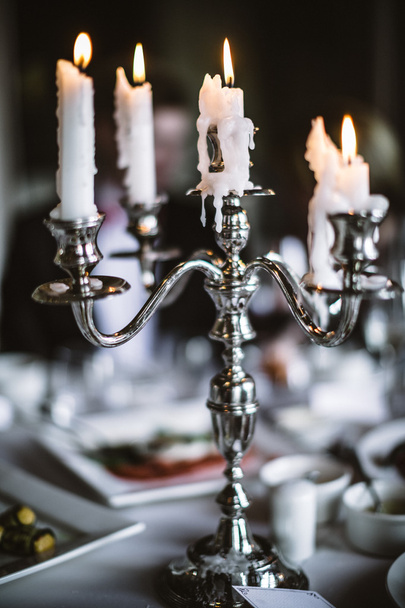 Tyylikäs antiikki kynttilänjalka tarjoillaan pöydälle
 - Valokuva, kuva