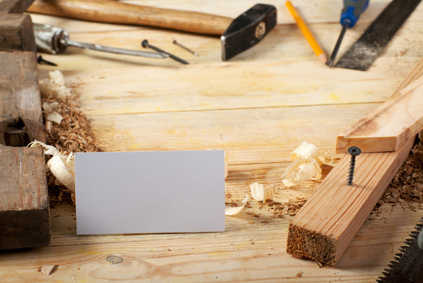 Carte de visite sur table en bois pour outils charpentier avec sciure de bois
. - Photo, image