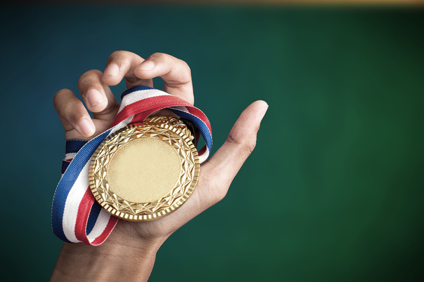 hand holding up a gold trophy - Photo, Image